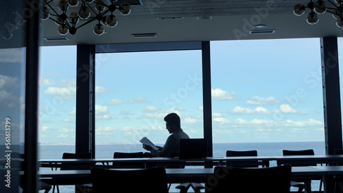 Wallpaper Mural Leader person reading papers at ocean view. Anonymous investor analyzing deal Torontodigital.ca