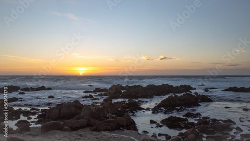 Beautiful sunset on the rocky beach of Pacific Grove in the Monterey Bay, California © gchapel