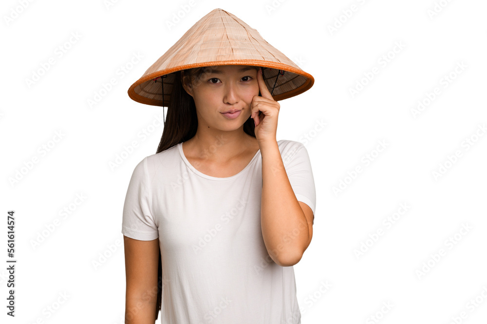Young asian woman wearing a Vietnamese hat isolated pointing temple with finger, thinking, focused on a task. Young asian woman wearing a Vietnamese hat isolated pointing temple with finger, thinking, focused on a task.