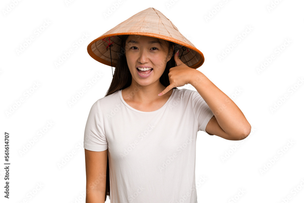 Young asian woman wearing a Vietnamese hat isolated showing a mobile phone call gesture with fingers. Young asian woman wearing a Vietnamese hat isolated showing a mobile phone call gesture with fingers.