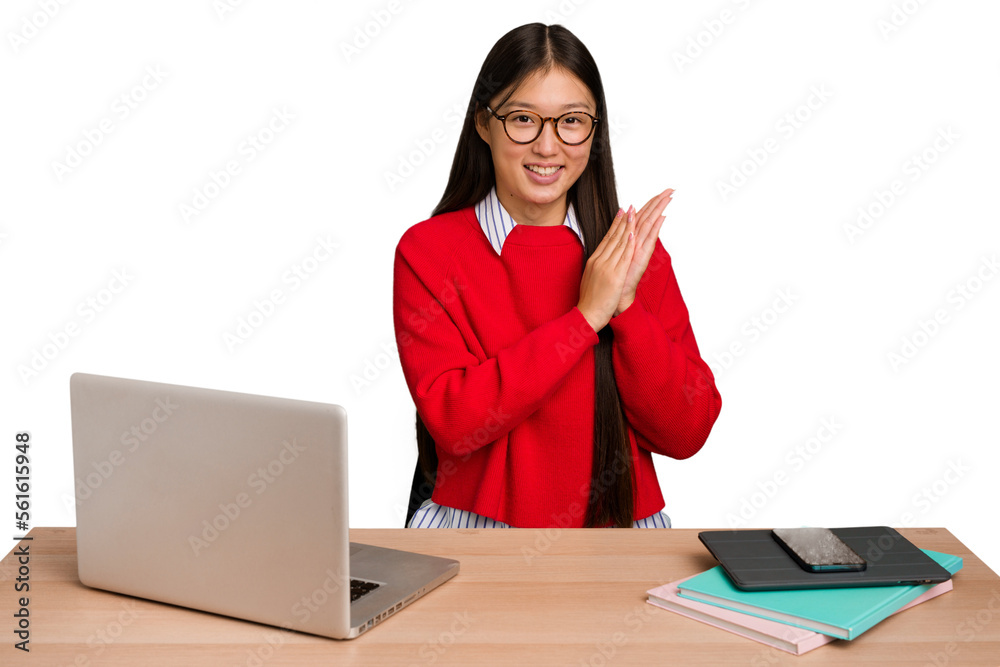 Φωτογραφία Young student asian woman in a workplace with a laptop isolated feeling energetic and comfortable, rubbing hands confident