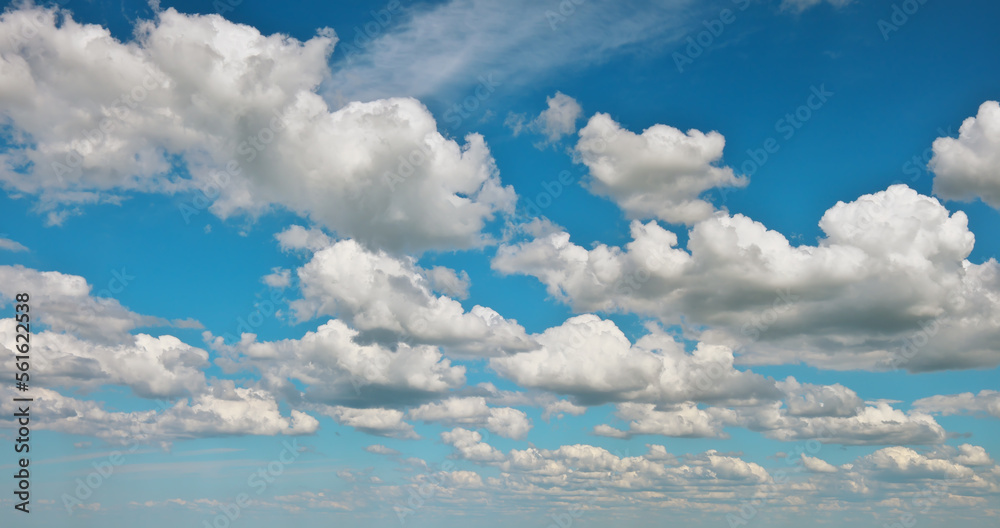 Fototapeta premium Blue sky background with fluffy clouds