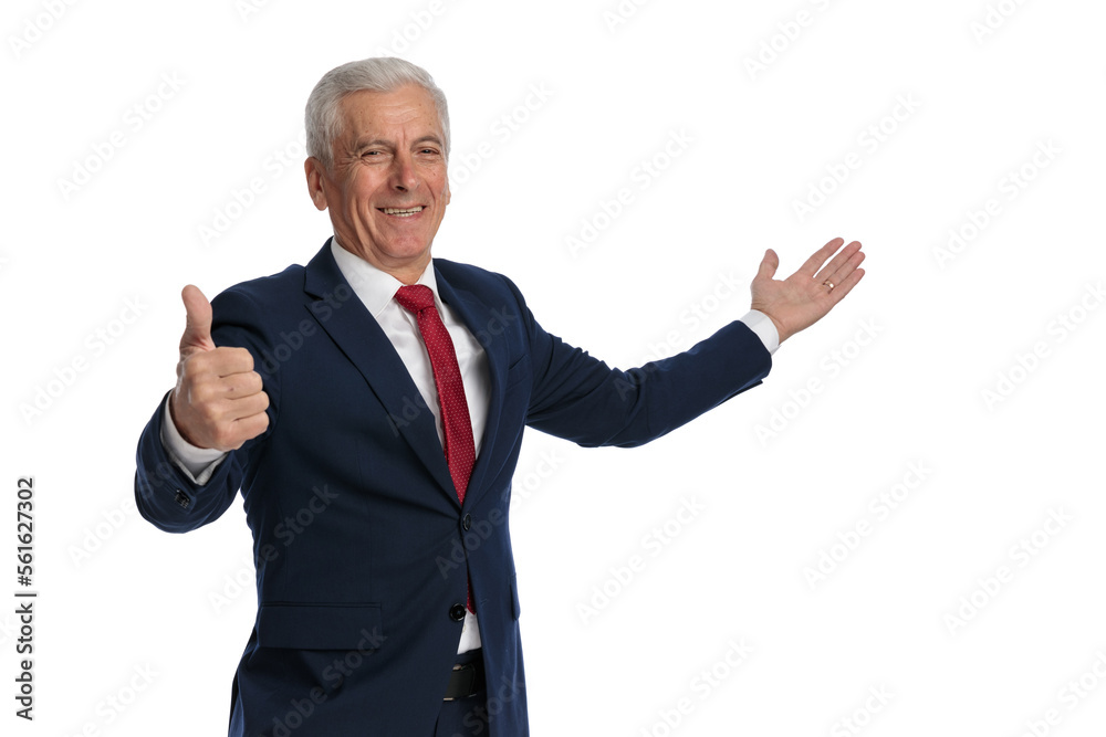 Old businessman giving a thumbs up and presenting Old businessman giving a thumbs up and presenting