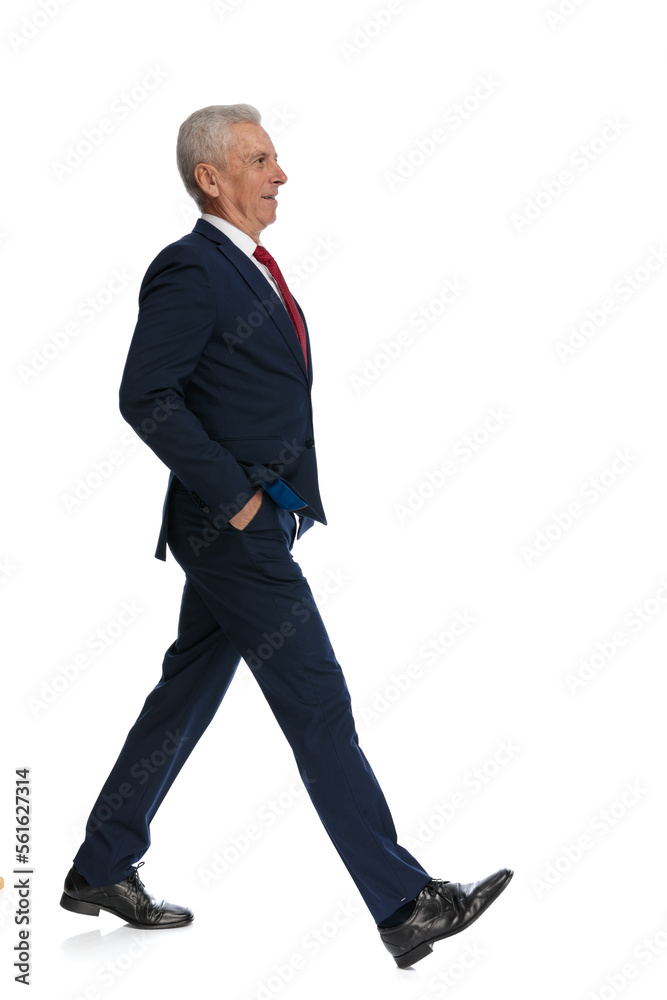 businessman walking along and putting his hands in his pockets businessman walking along and putting his hands in his pockets