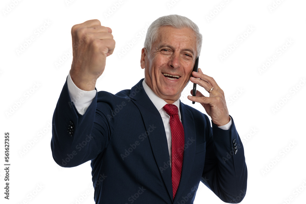 businessman talking on the phone while celebrating businessman talking on the phone while celebrating