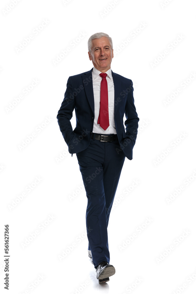 Happy old businessman walking towards the camera Happy old businessman walking towards the camera