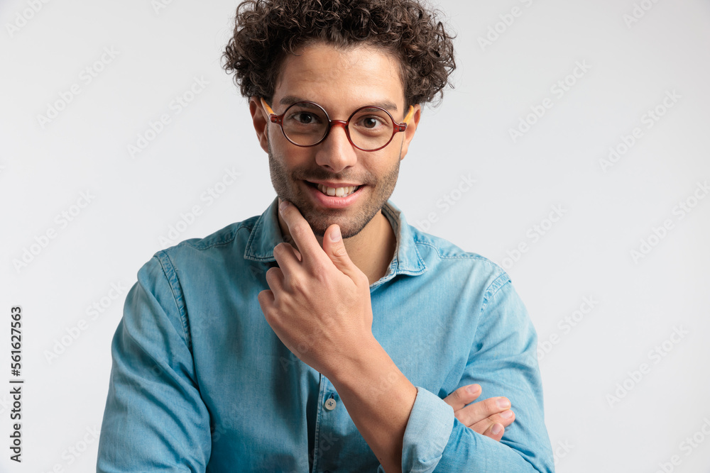 casual man scratching his chin and feeling happy casual man scratching his chin and feeling happy