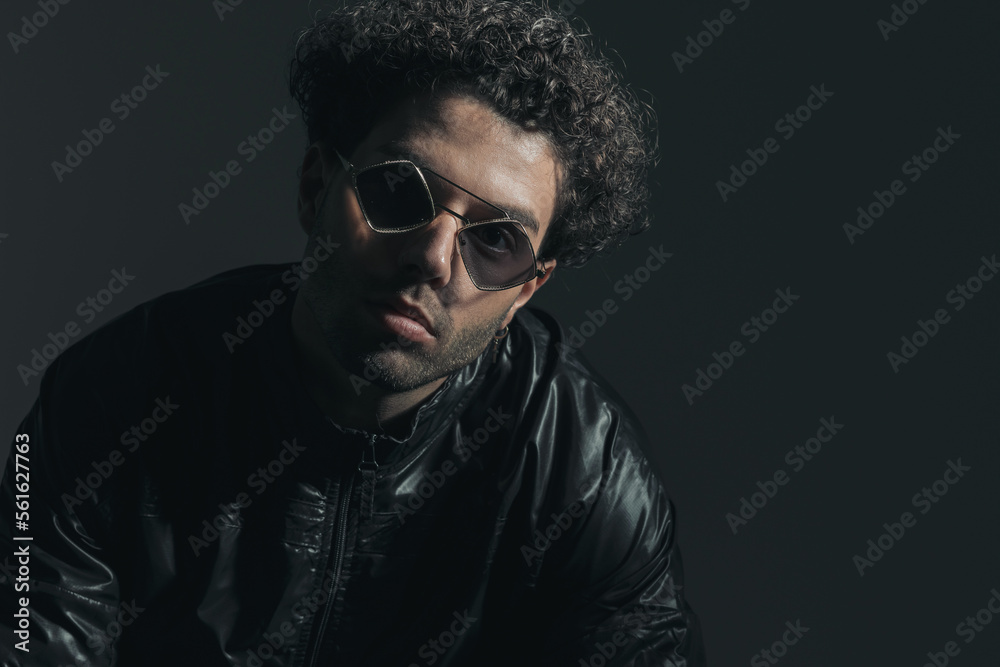 handsome lebanese man with sunglasses and curly hair posing handsome lebanese man with sunglasses and curly hair posing