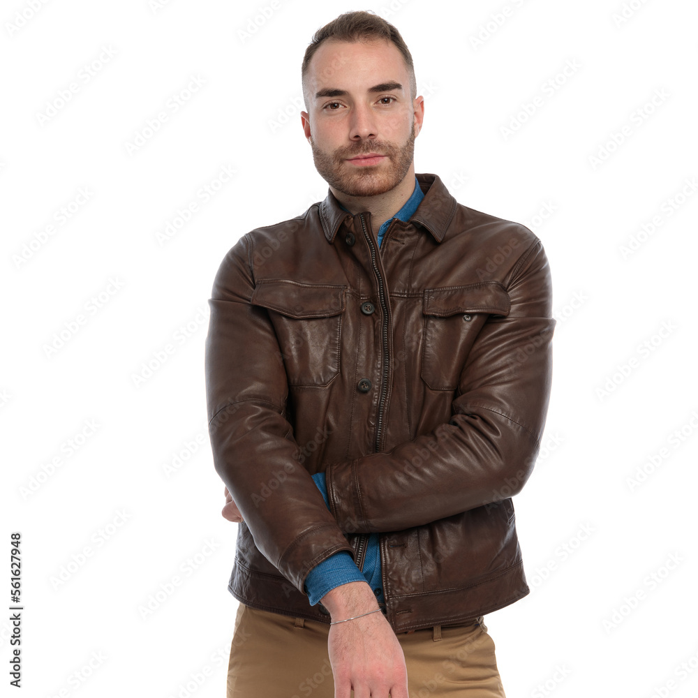portrait of cool casual man wearing brown leather jacket and posing portrait of cool casual man wearing brown leather jacket and posing