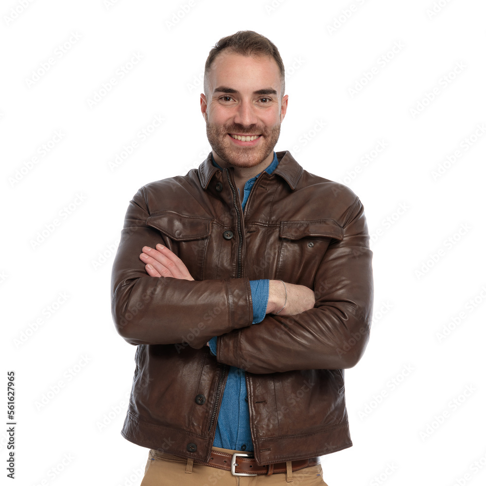 excited casual guy in brown leather jacket crossing arms and smiling excited casual guy in brown leather jacket crossing arms and smiling