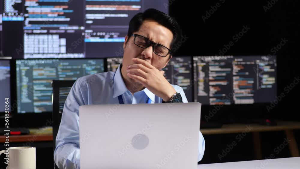 Asian Male Programmer Yawning And Sleeping While Writing Code By A ...