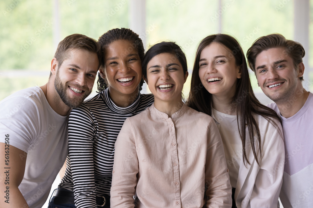 Multiethnic team of joyful happy students, interns, friends posing close together, looking at camera with toothy smiles, laughing, enjoying meeting, social communication, group success Multiethnic team of joyful happy students, interns, friends posing close together, looking at camera with toothy smiles, laughing, enjoying meeting, social communication, group success