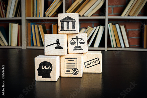 Copyright or patent law concept. Wooden cubes with marks on the desk. photo