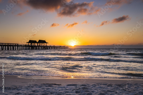 Sun setting at Naples pier post hurricane Ian Naples, Florida USA November 2022
