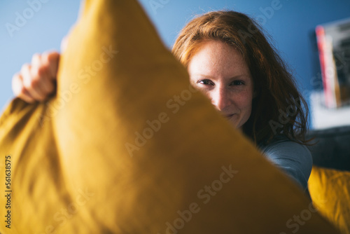 Woman about to start a pillow fight at home photo