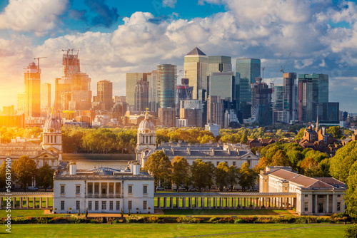 London at Sunset Light, England,  Skyline View Of Greenwich College and Canary Wharf At Golden Hour Sunset With Blue Sky And Clouds photo