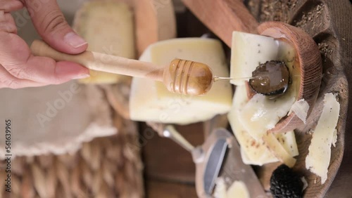 Pecorino cheese with truffle, traditional Italian sheep's milk cheese with truffle. A typical product of the dairy regions of Tuscany and Sardinia. Honey and cheese. High quality HD video. Vertical