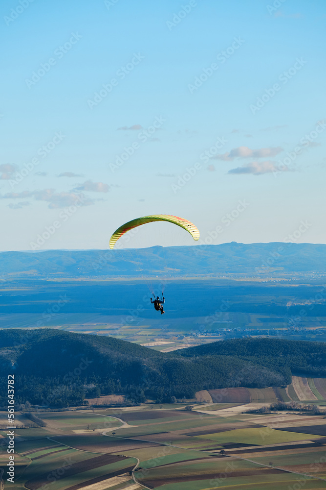 paraglider in the sky over the sun-drenched austrian valley paraglider in the sky over the sun-drenched austrian valley