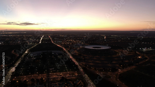 Aerial view of the monumental axis of the capital of Brazil at dusk, showing the Mané Garrincha stadium and a view of the skyline of Brasilia, Federal District photo