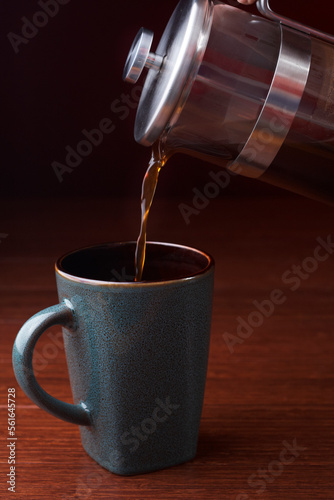  French press and a coffee cup