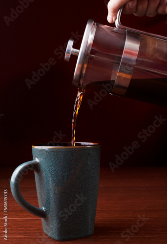  French press and a coffee cup