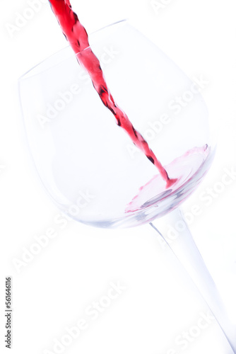 wine poured into a glass on a white background