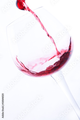 wine poured into a glass on a white background