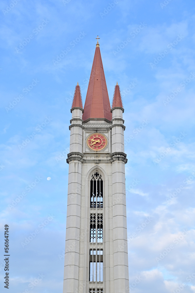 SAMUT PRAKAN, THAILAND - January 16, 2023: The Landmark of Clock Tower and Moon with blue sky and white cloud, Clear day and good weather in the morning, Thailand.