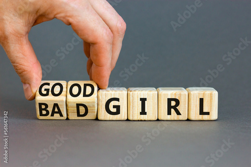 Good or bad girl symbol. Concept word Good girl Bad girl on wooden cubes. Businessman hand. Beautiful grey table grey background. Business psychological good or bad girl concept. Copy space.