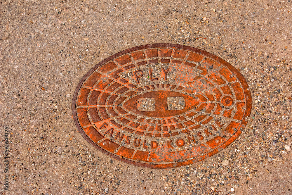 Manhole cover of the gas pipeline system. A massive metal hatch for access to city communications in the pavement.