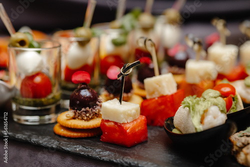 Foto appetizing aperitifs on the plate , canape with cheese .
