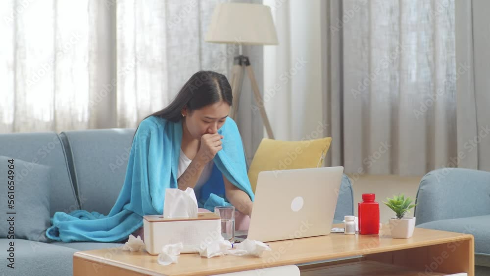 Asian Woman With Blanket Suffering From Cough While Sitting On Sofa Works On A Laptop Computer In The Living Room At Home
Asian Woman With Blanket Suffering From Cough While Sitting On Sofa Works On A Laptop Computer In The Living Room At Home