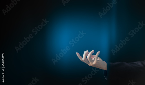 Businessman and gesture topic: a man in a black suit hand gesture on an on abstract background in studio