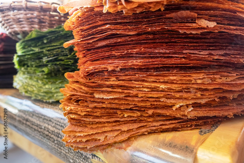 Pile of Tklapi - traditional georgian pastila or fruit leather. Colorful dried mushed fruit sheets sold at food market for tourists. Delicious and healthy Georgian and Armenian sweet dessert photo
