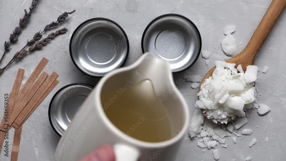 Close up of melted soy wax gets poured into small cans