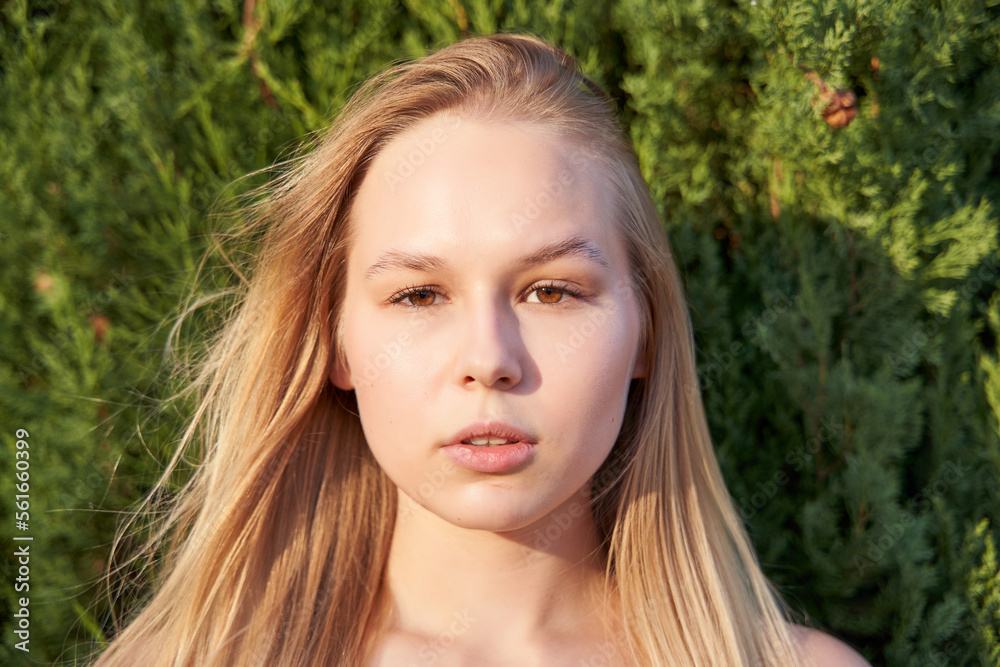 Close up of young woman face, natural blonde hair, has no makeup, looking at camera. Close up of young woman face, natural blonde hair, has no makeup, looking at camera.