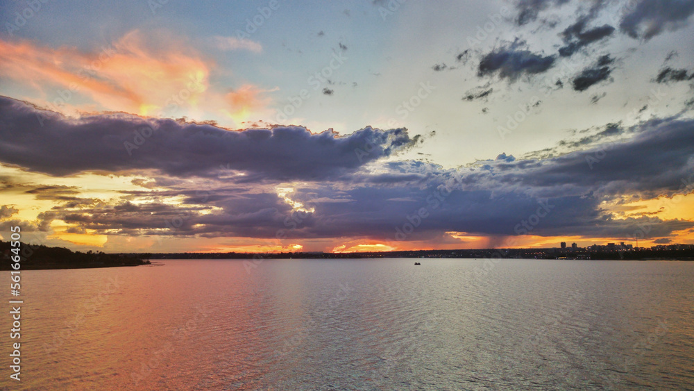 night photo of the Paranoa lake in Brasilia with the horizon in the background showing the sky with blue and orange clouds at dusk