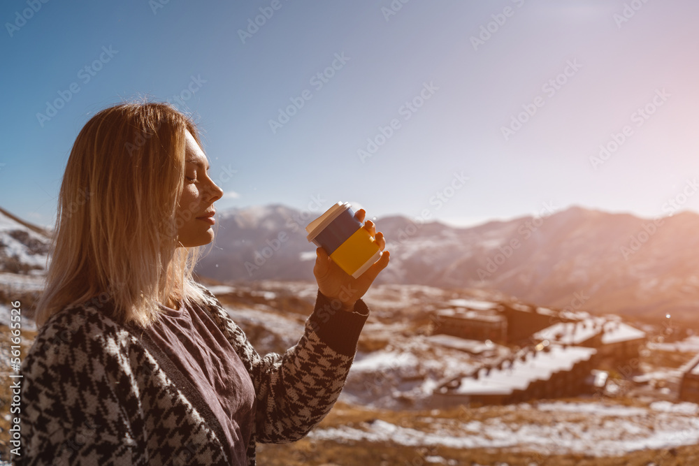 Ukrainian female drink hot coffee drink from disposable cup at nature, mountains Ukrainian female drink hot coffee drink from disposable cup at nature, mountains