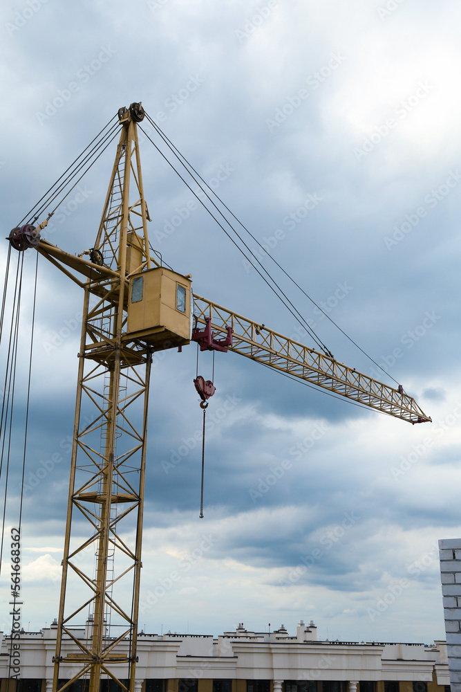 Fototapeta premium Construction site with tower crane under beautiful cloudy sky