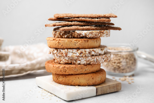 Stack of rye crispbreads, rice cakes and rusks on white table