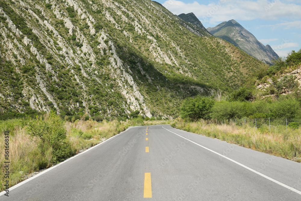 Fototapeta premium Beautiful view of empty asphalt highway near mountains outdoors. Road trip