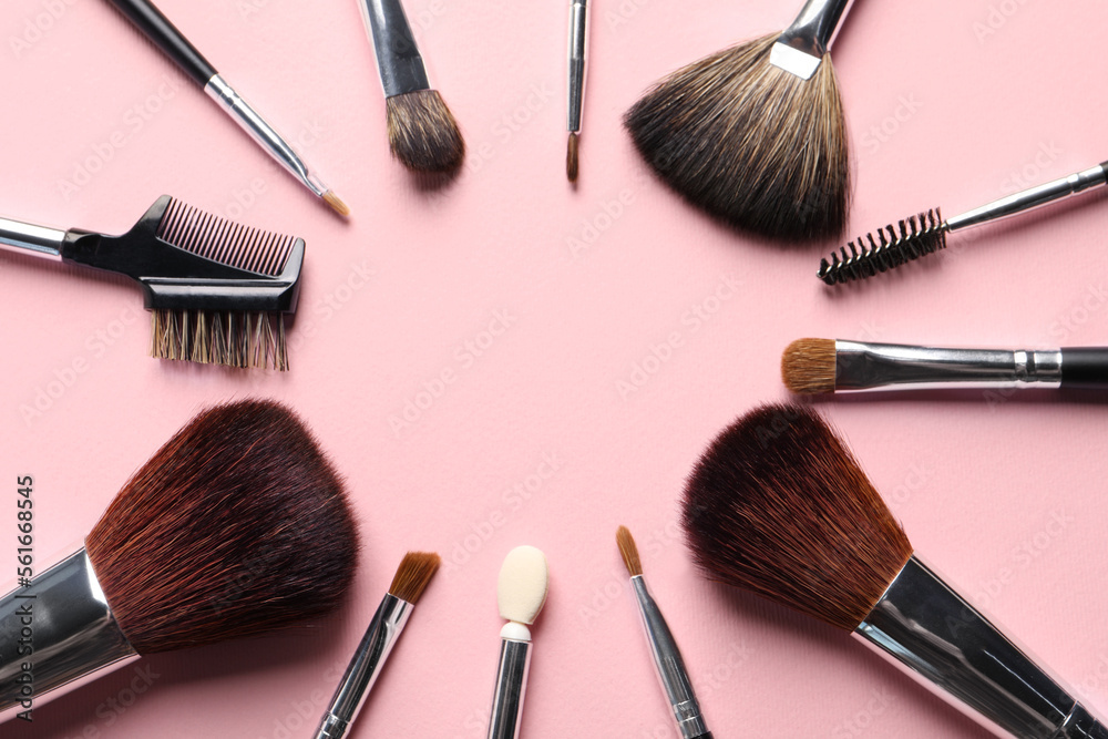 Frame of different makeup brushes on pink background, flat lay. Space for text Frame of different makeup brushes on pink background, flat lay. Space for text