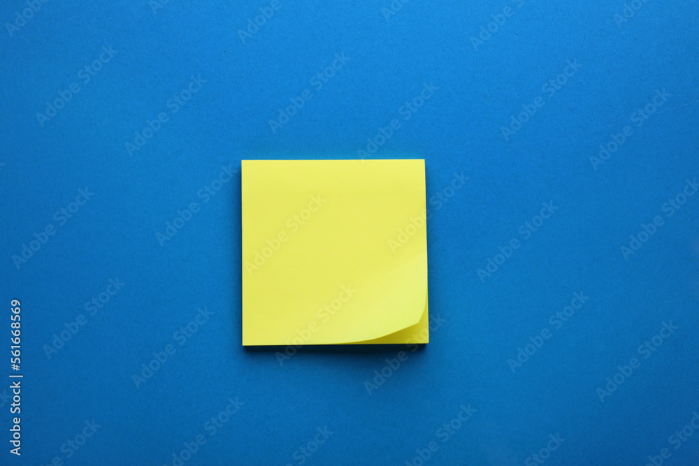 Paper note on blue background, top view Paper note on blue background, top view
