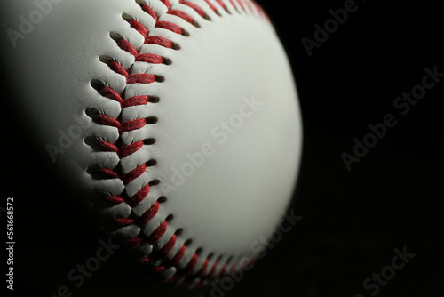 Baseball ball on black background, closeup with space for text. Sports game
