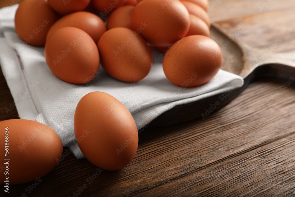 Raw brown chicken eggs on wooden table, closeup Raw brown chicken eggs on wooden table, closeup