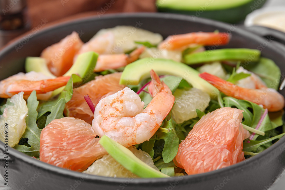 Delicious pomelo salad with shrimps on table, closeup view