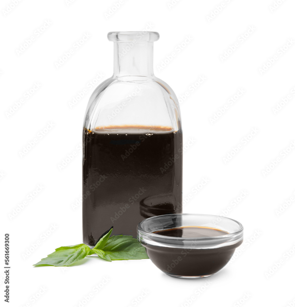 Organic balsamic vinegar and basil isolated on white Organic balsamic vinegar and basil isolated on white