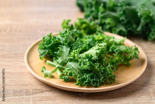 Green Kale or leaf cabbage on wooden plate, Healthy vegetable
