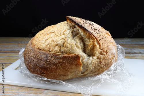 Traditional Sour dough isolated on plastic chopping board. Famous starter bread menu in restaurant.