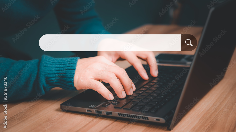 Mature man hand working with laptop computer on table in his home. Search the Internet with an empty search bar. Best SEO search networking, Searching browsing internet data information concept. Mature man hand working with laptop computer on table in his home. Search the Internet with an empty search bar. Best SEO search networking, Searching browsing internet data information concept.